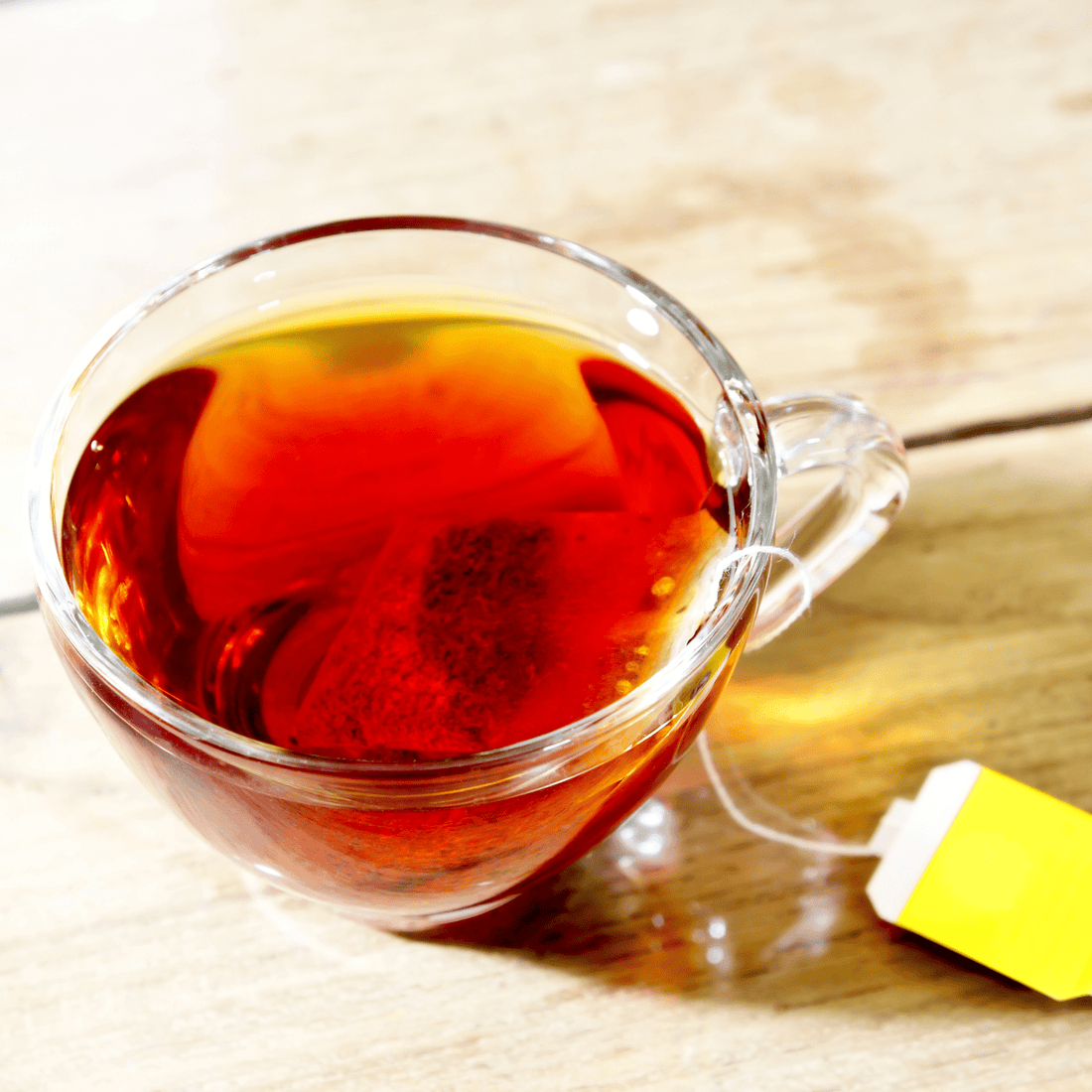 Cup of tea in a clear glass with tea bag Reishi tincture Celestial Seasonings